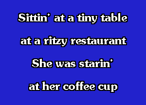 Sittin' at a tiny table
at a ritzy restaurant
She was starin'

at her coffee cup